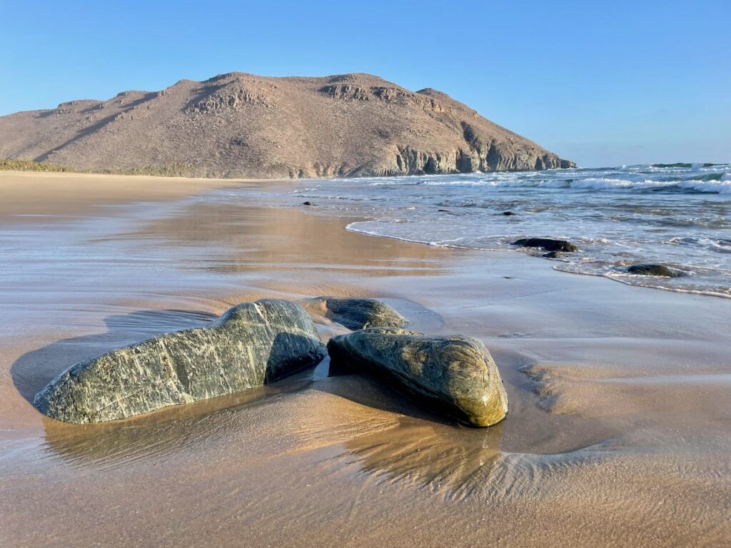 Emerald rocks looking south along the beaach Playa Las Palmas