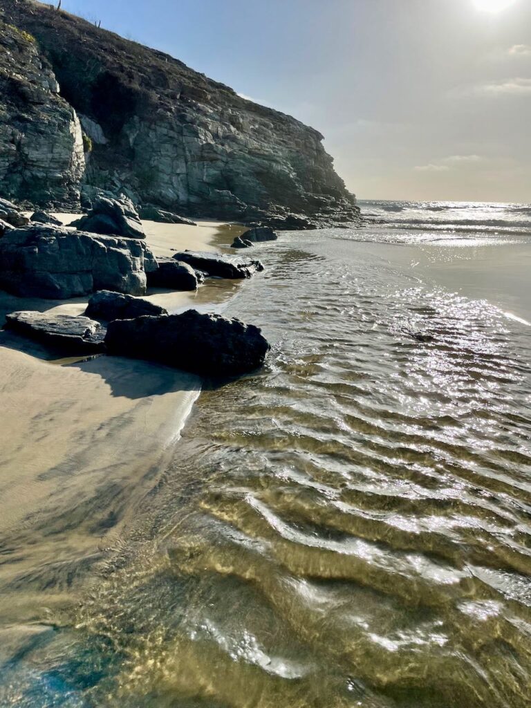 Ripples in sand river leading to sea Playa Las Palmas