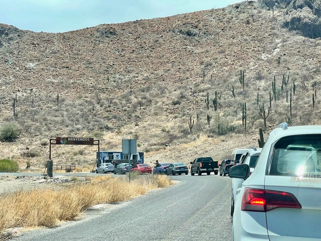 Cars entering the gate at Playa Balandra